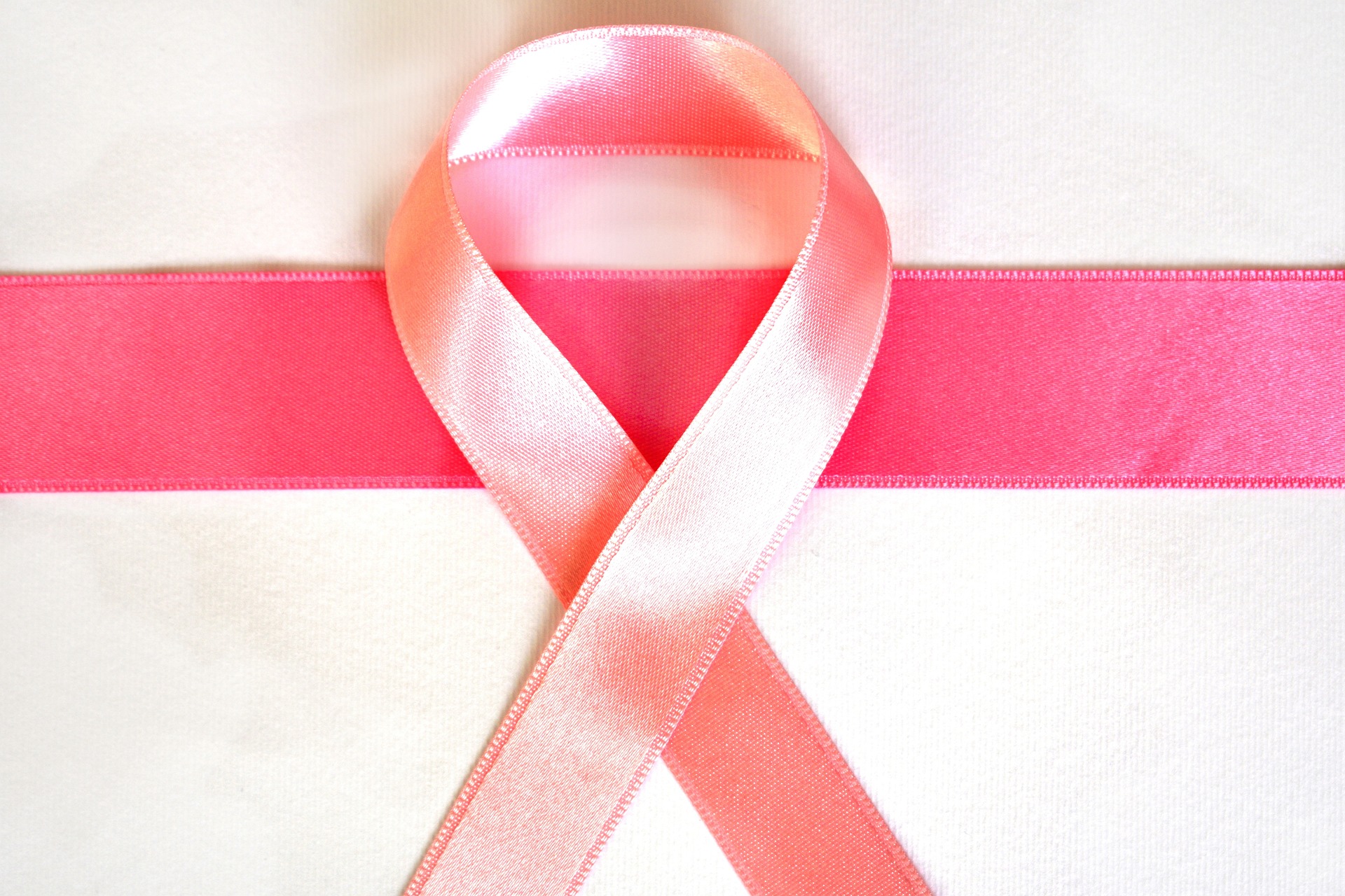 Pink Cancer Ribbon again pink and white background. 